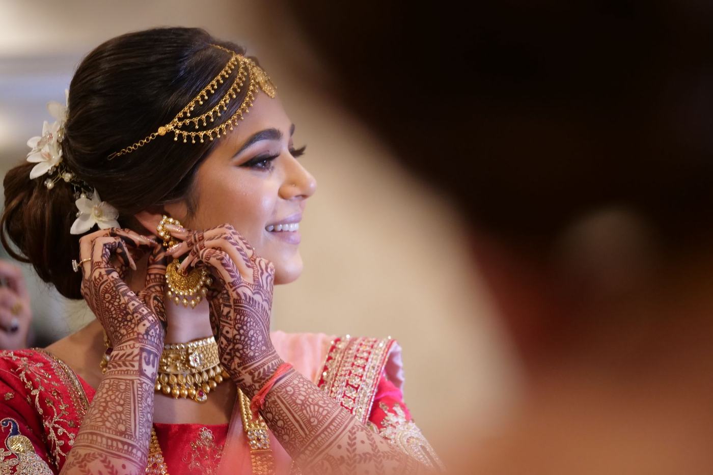 Bride fastening her earring as she gets ready