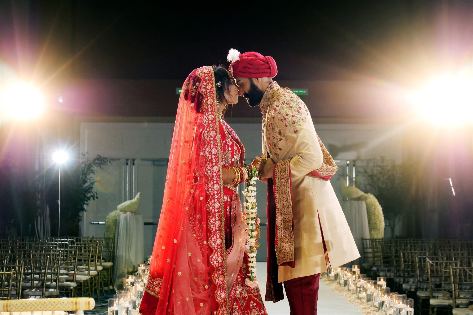Bride and groom standing close together under warm light after the ceremony
