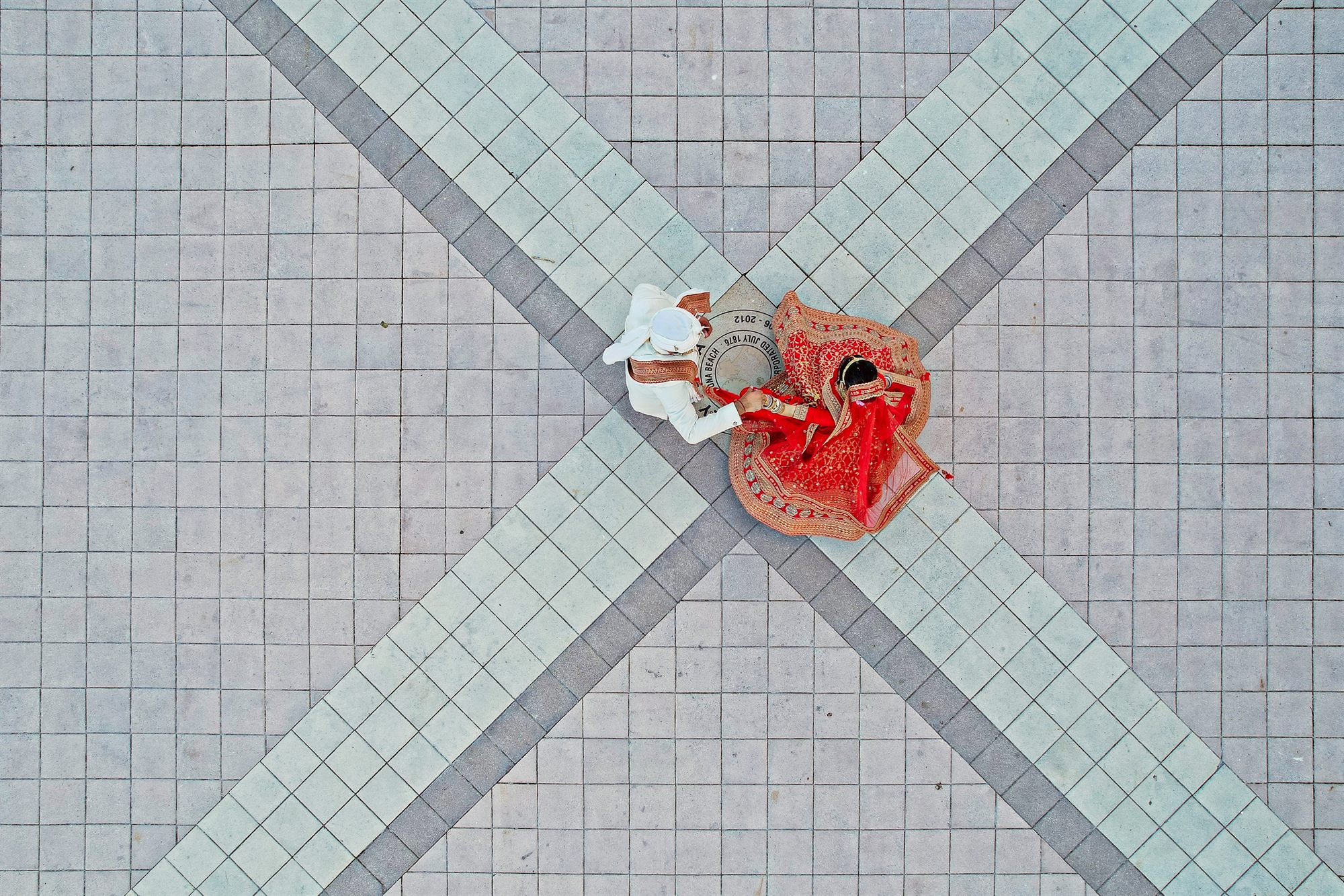 Bride photographed from directly above on a tiled courtyard