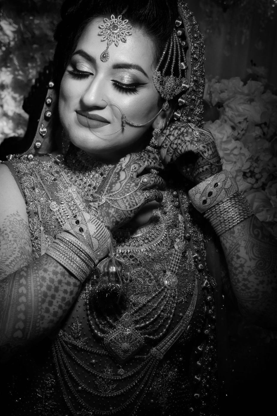 Bride turning away in black and white, jewels catching the light