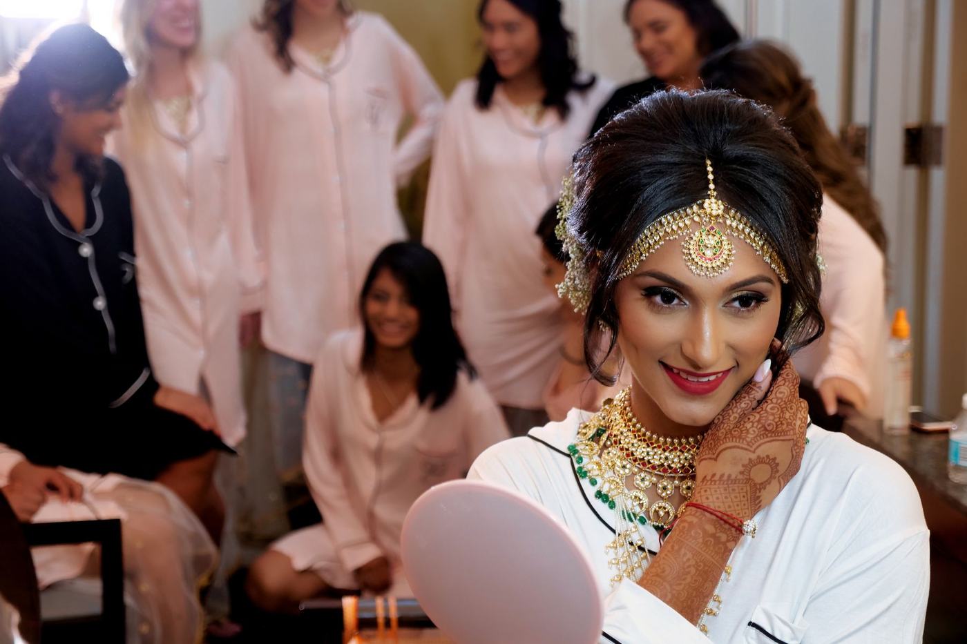 Bride surrounded by her friends as she gets ready