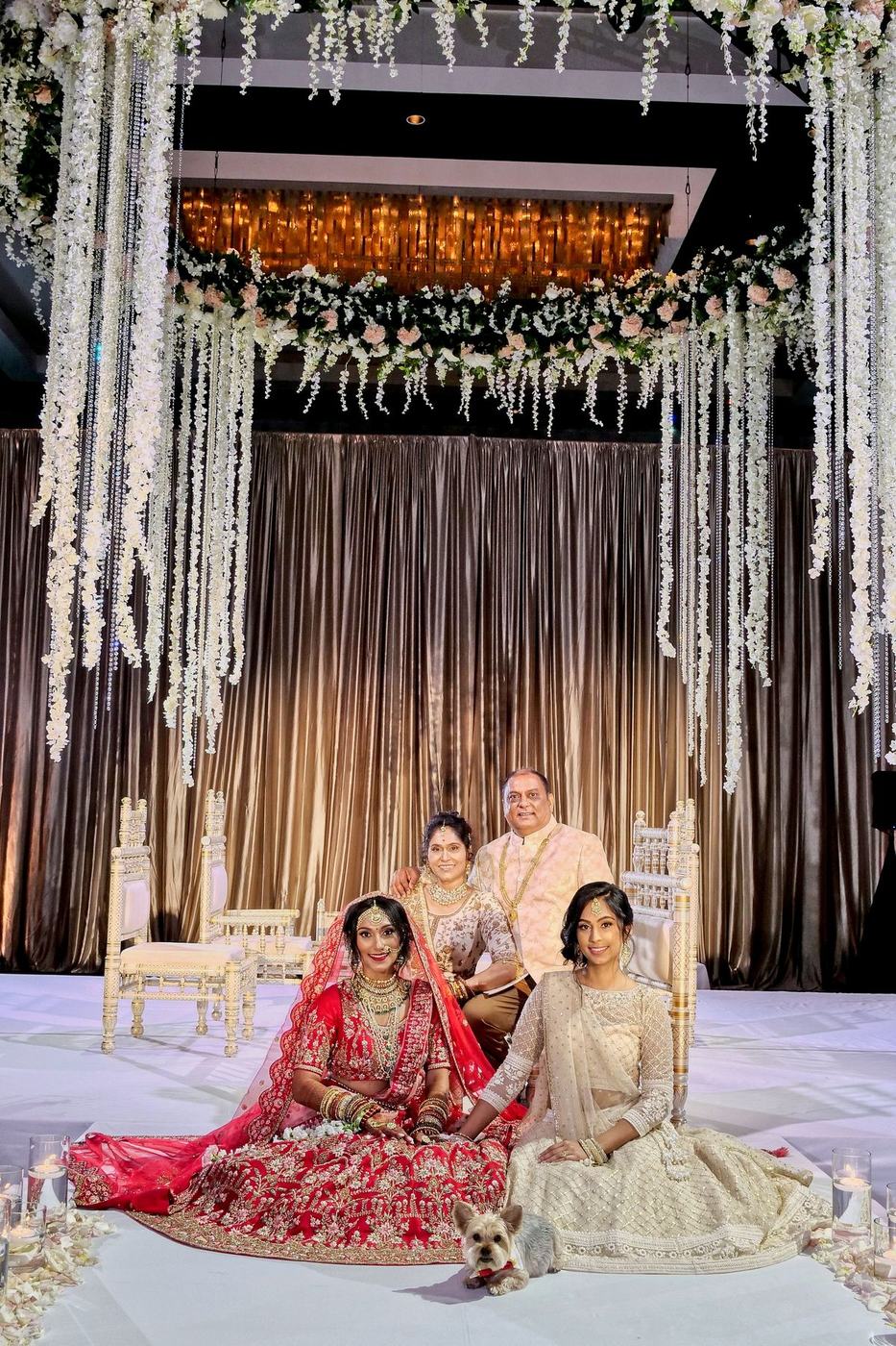 Bride with her parents on the stage at Hilton Orlando