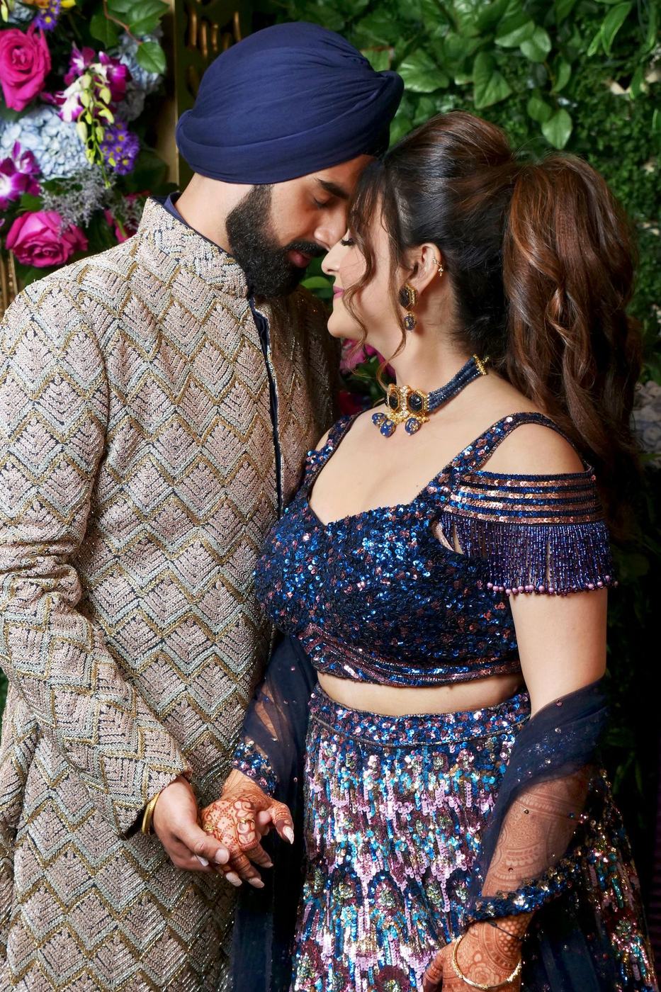 Couple in navy sequins and a matching sherwani at the reception