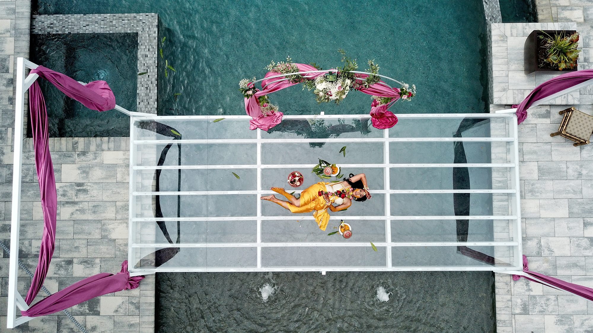 Couple photographed from above, framed by the geometry of a courtyard