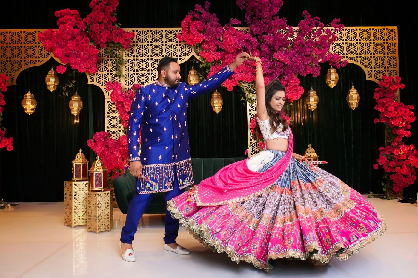 Couple striking a dance pose before the bougainvillea stage