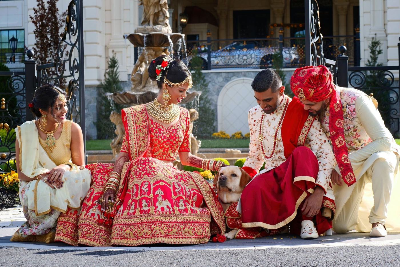 Bride and groom with their golden retriever on the steps at Park Chateau Estate