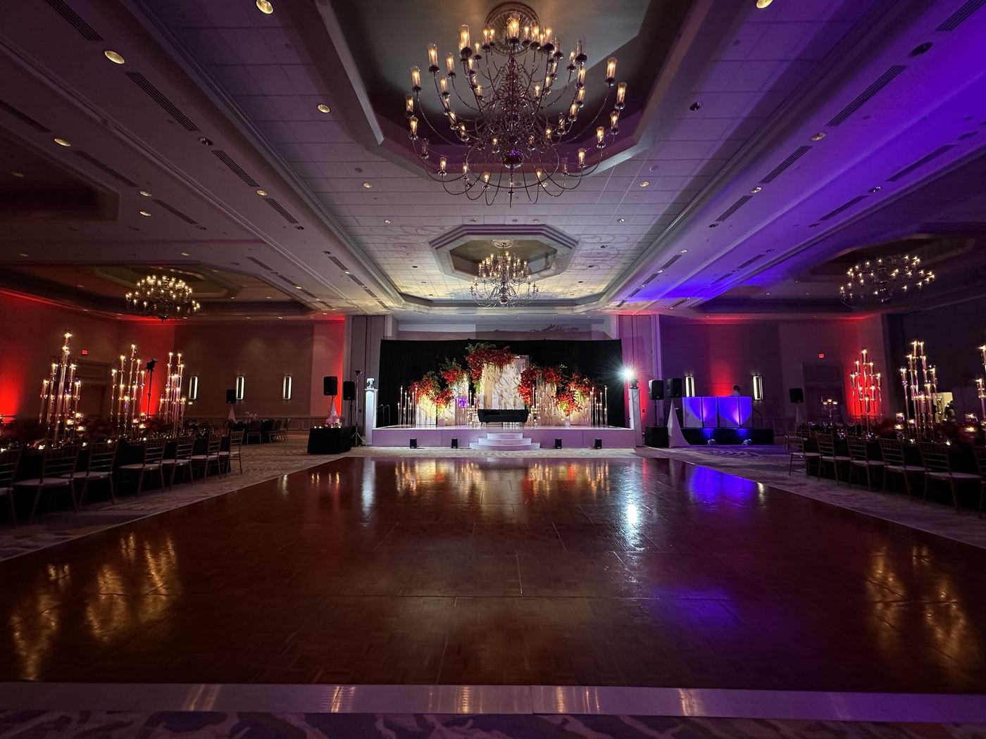 Empty dance floor and stage before the reception, lit in purple