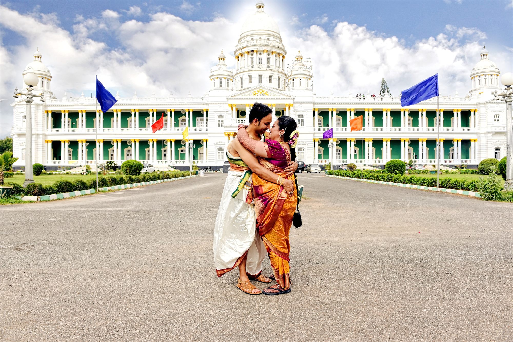 Family embracing the couple in front of a palace facade