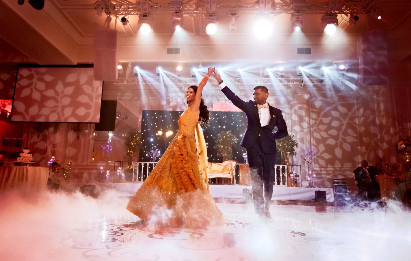 First dance through low white smoke under spotlights