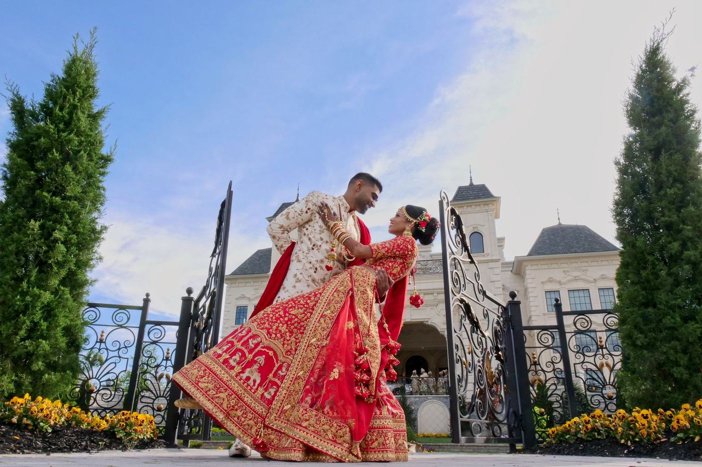 Groom dipping the bride at the gates of Park Chateau Estate