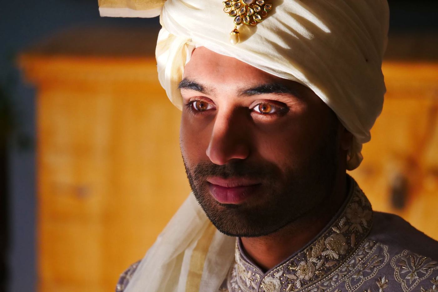 Groom in a cream safa, a quiet portrait before the ceremony
