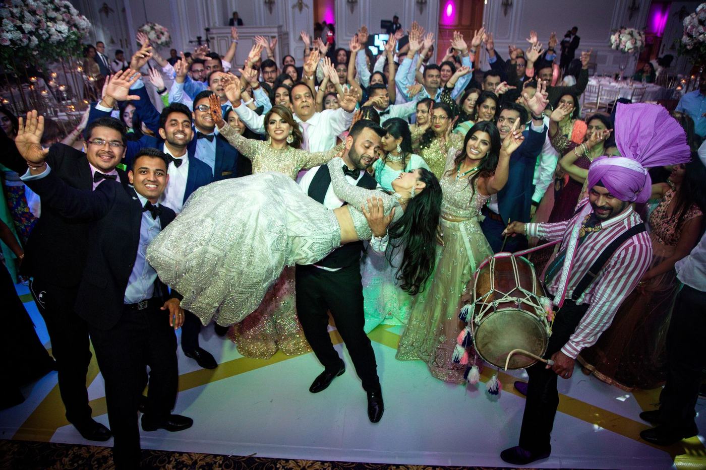 Groom lifted by the crowd on the dance floor
