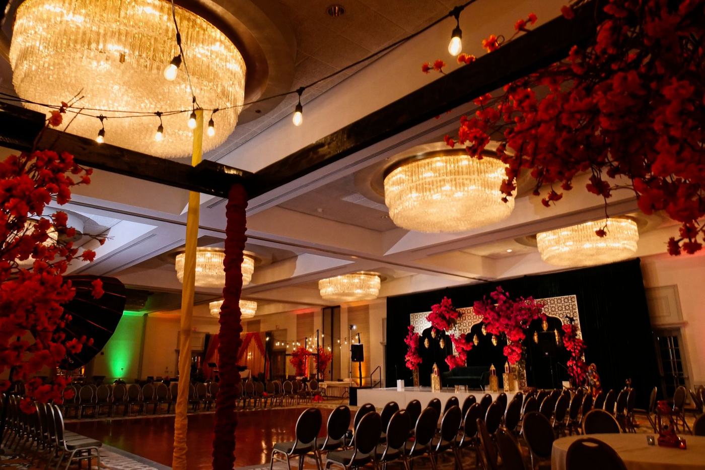 Hilton Orlando ballroom dressed in red florals with chandeliers overhead