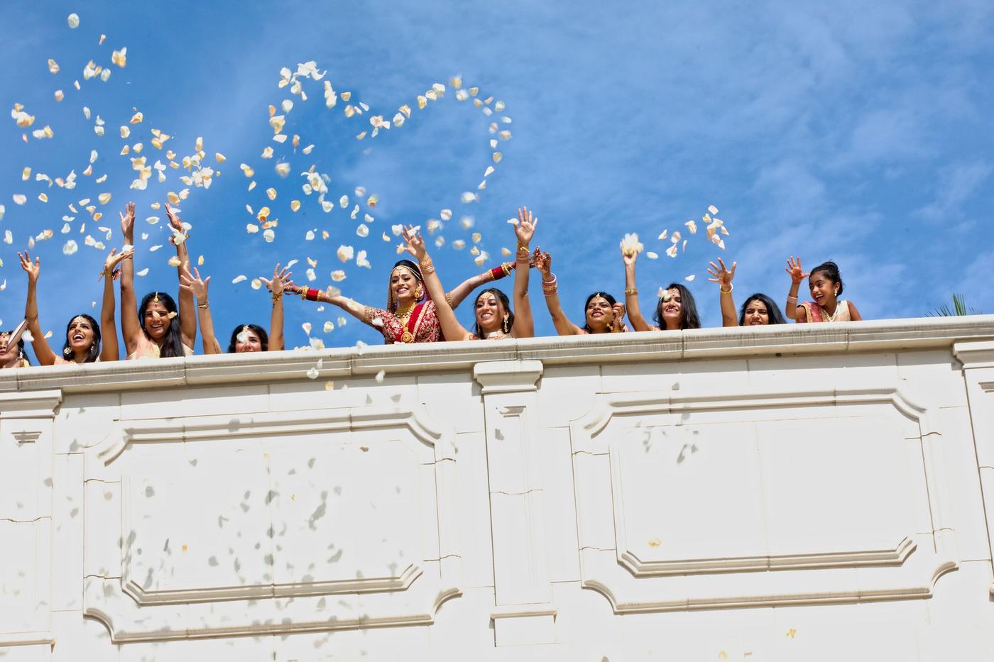 Petals thrown from the balcony into a blue sky