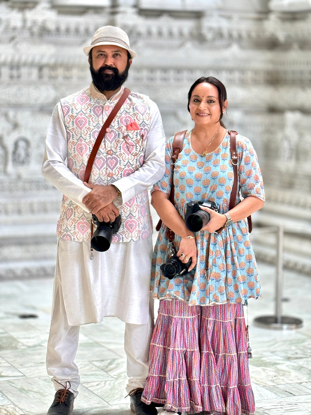Chirali and Amish Thakkar photographing together at a wedding venue